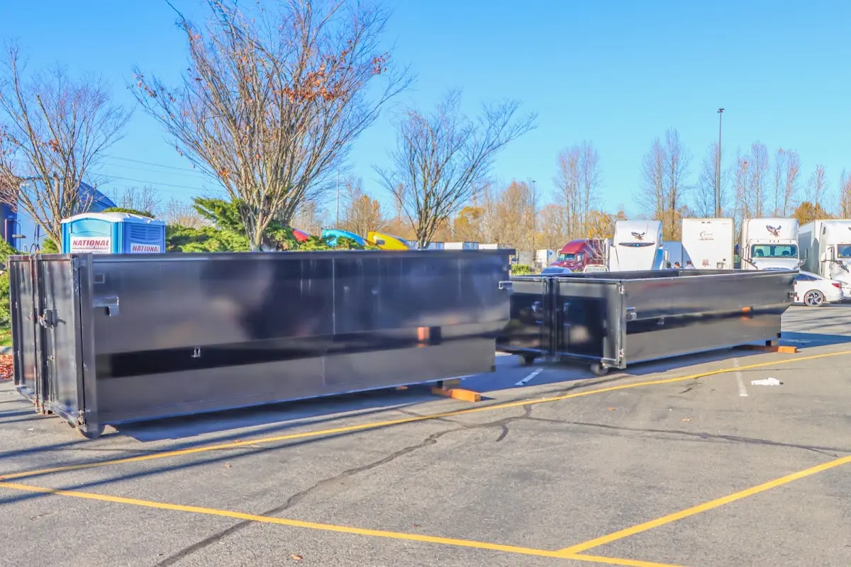 Professional dumpster rental service with roll-off container on residential driveway in Cinco Ranch